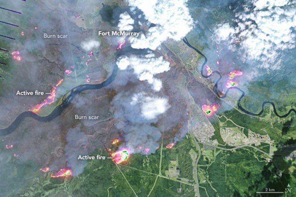 An image acquired by the Enhanced Thematic Mapper Plus on the Landsat 7 satellite shows Fort McMurray on May 4, 2016. On this day, the fire spanned about 100 square kilometers; by the morning of May 5, it spanned about 850 square kilometers; the fire eventually burned almost 6,000 square kilometers. (Credit: NASA)