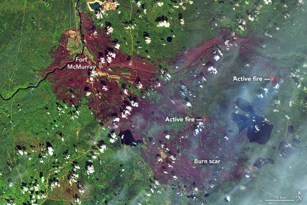 The Operational Land Imager on Landsat 8 acquired this false-color image of the burn scar on May 12. Infrared bands can penetrate clouds and smoke to reveal hotspots associated with active fires (red). (Credit: NASA Earth Observatory image by Joshua Stevens, using Landsat data from USGS)